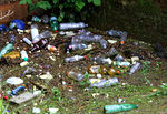 plastic bottles and other rubbish on the heavily polluted river